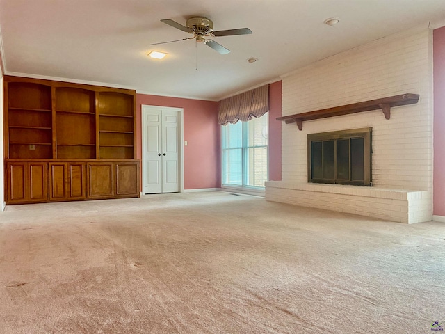 unfurnished living room featuring ceiling fan, a fireplace, and light carpet