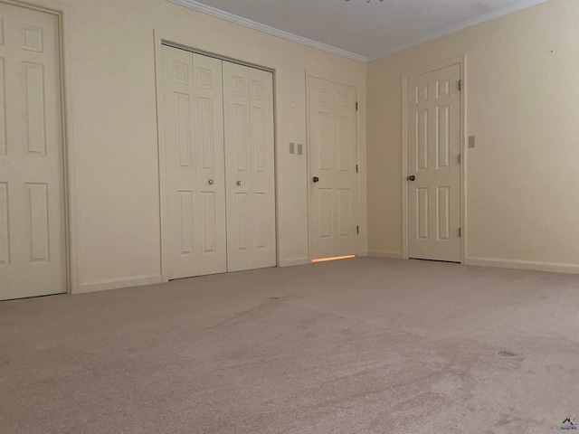 unfurnished bedroom with carpet and crown molding