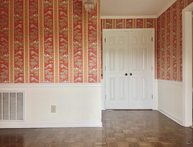 interior space with dark parquet floors and ornamental molding