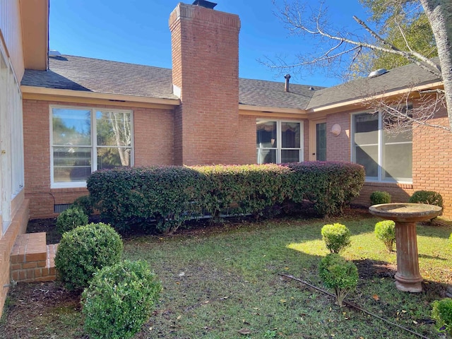 view of property exterior with a lawn