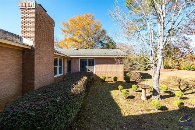 view of side of property with a lawn