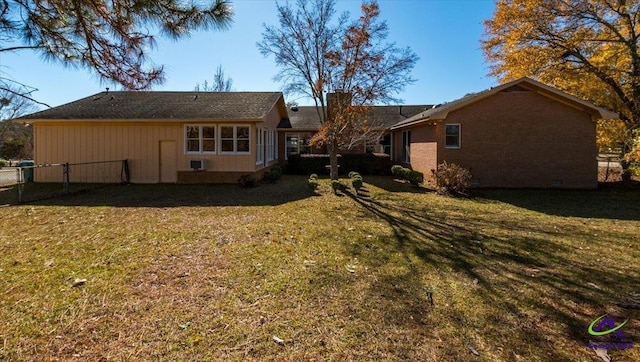 rear view of house with a yard