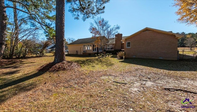 rear view of property featuring a yard