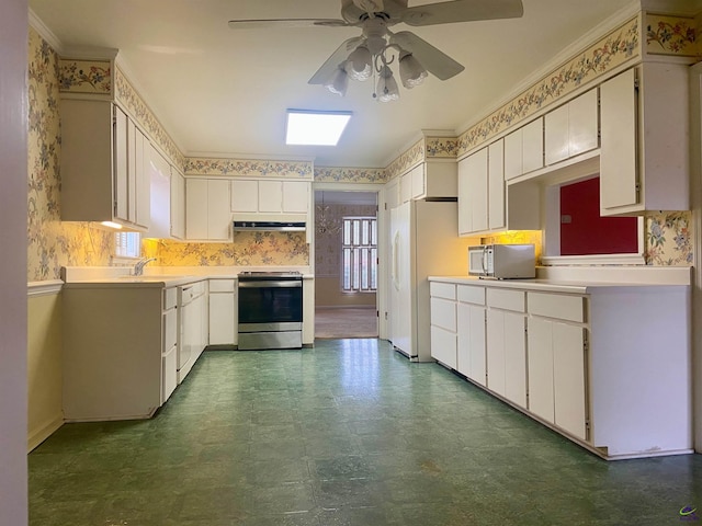 kitchen with ceiling fan, sink, stainless steel appliances, crown molding, and white cabinets