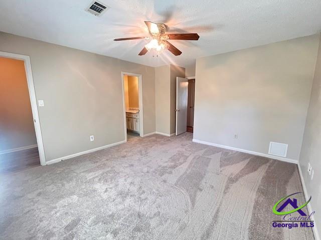 carpeted empty room with ceiling fan