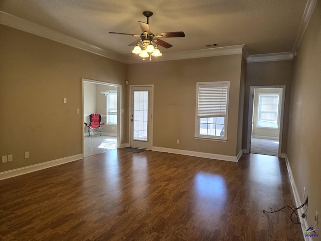 empty room featuring a textured ceiling, ceiling fan, ornamental molding, and dark hardwood / wood-style flooring