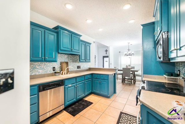 kitchen featuring appliances with stainless steel finishes, blue cabinetry, light tile patterned floors, pendant lighting, and an inviting chandelier