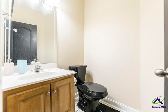 bathroom with tile patterned floors, vanity, and toilet