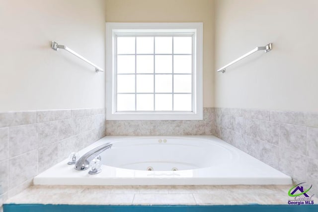 bathroom with a relaxing tiled tub