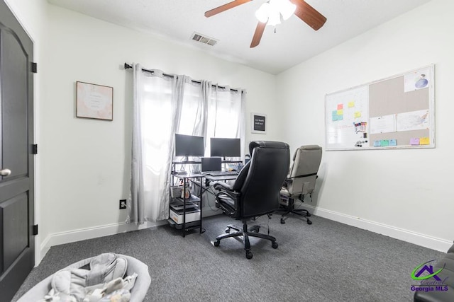 office space featuring ceiling fan and dark colored carpet