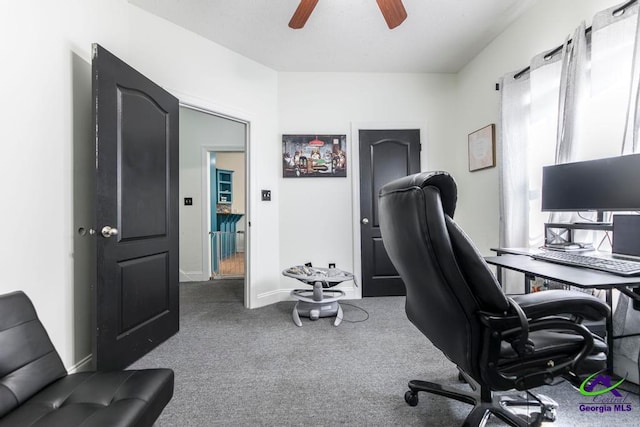 carpeted office featuring ceiling fan