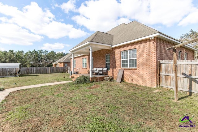 view of front facade featuring a front yard and a patio