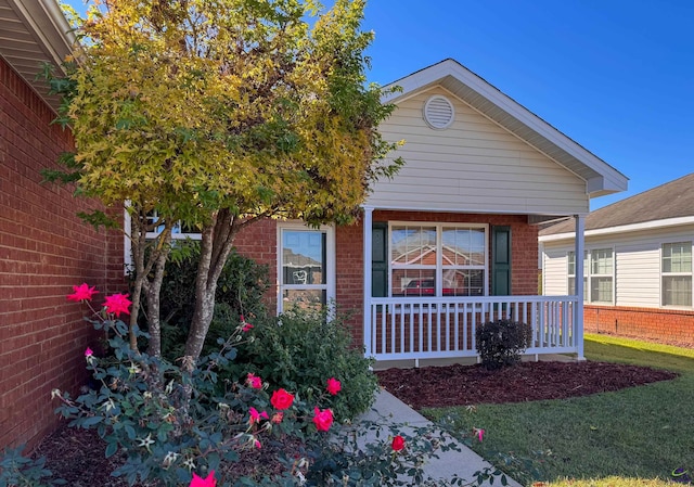 view of front of property with covered porch and a front yard