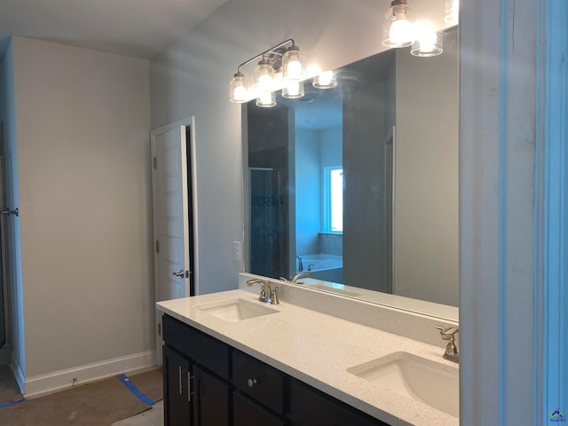 bathroom with vanity and a bath