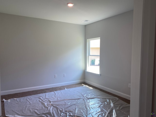 unfurnished room featuring carpet