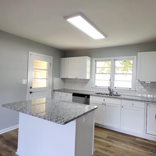 kitchen featuring white cabinets, a center island, dark wood-type flooring, and sink