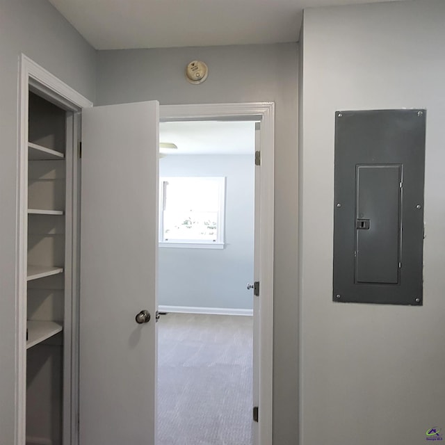 corridor with carpet floors and electric panel