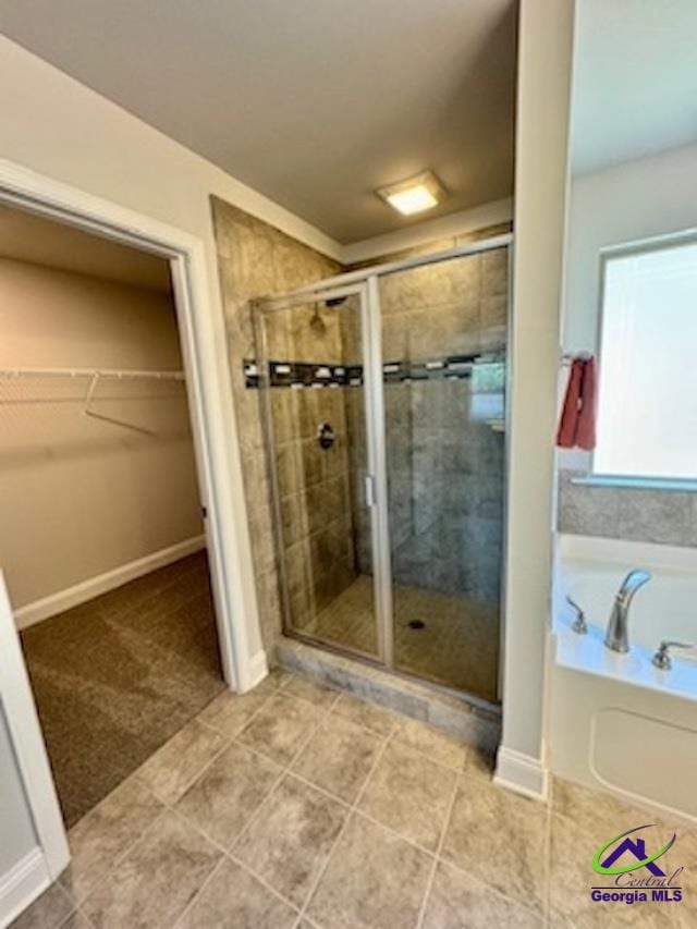 bathroom featuring tile patterned floors and plus walk in shower