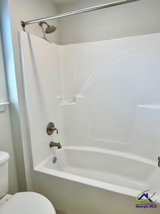 bathroom with shower / bath combination and toilet