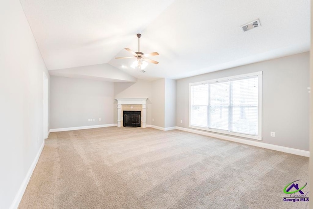 unfurnished living room featuring ceiling fan, lofted ceiling, and light carpet