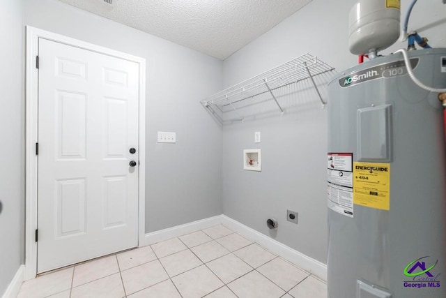 washroom featuring electric dryer hookup, electric water heater, hookup for a washing machine, and light tile patterned flooring