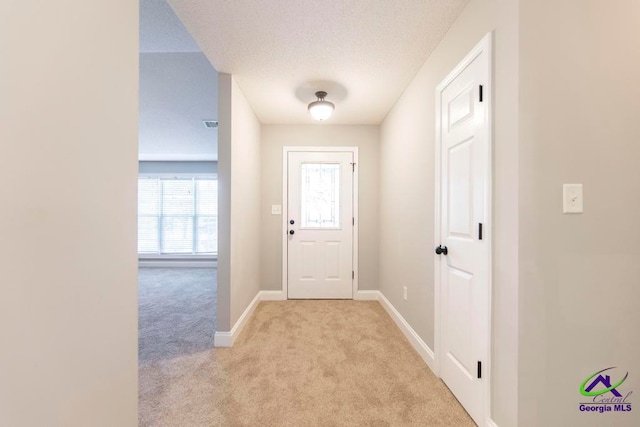 doorway featuring light colored carpet