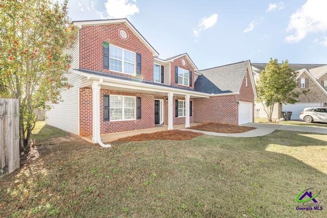 view of front of house with covered porch, a front yard, and a garage