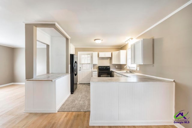 kitchen featuring kitchen peninsula, black electric range, light wood-type flooring, white cabinetry, and stainless steel fridge with ice dispenser