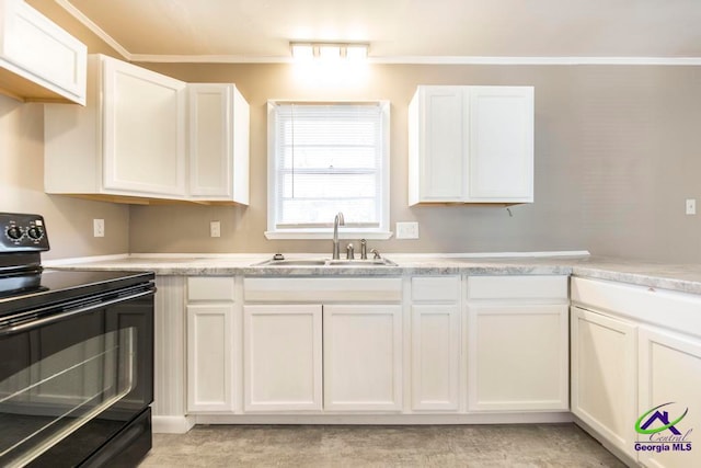 kitchen featuring crown molding, black electric range, white cabinets, and sink