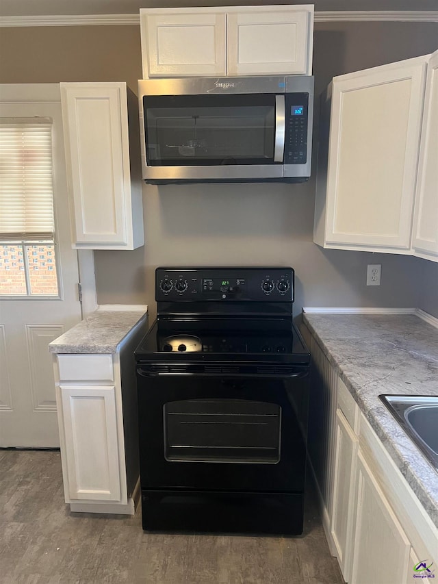 kitchen featuring white cabinets, black electric range oven, crown molding, and light hardwood / wood-style flooring