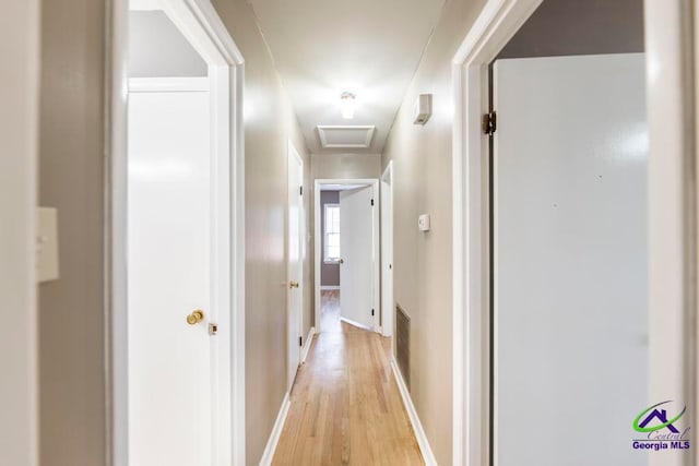 hallway with light hardwood / wood-style flooring