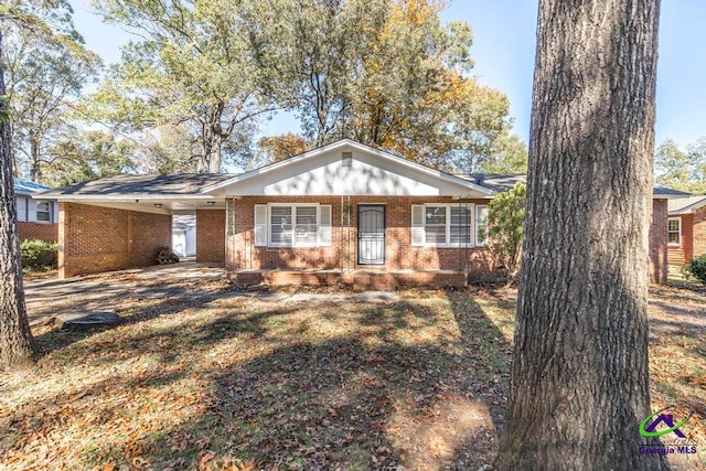 single story home featuring a carport