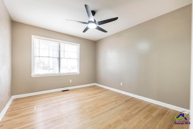 empty room with ceiling fan and light wood-type flooring