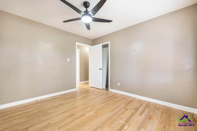 spare room with ceiling fan and light wood-type flooring