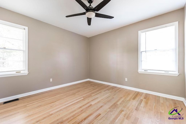 unfurnished room with light hardwood / wood-style floors, ceiling fan, and a healthy amount of sunlight