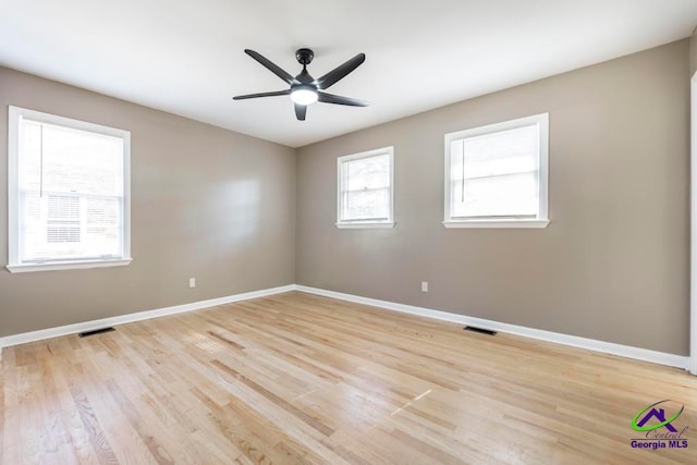 spare room featuring light wood-type flooring and ceiling fan