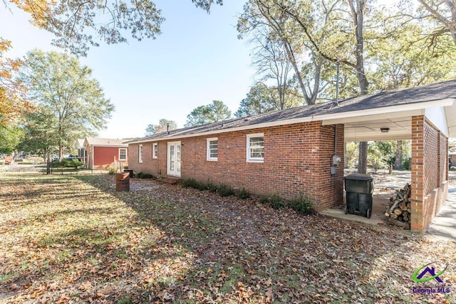 view of home's exterior featuring a carport and a lawn