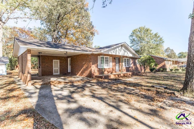 ranch-style house featuring a carport and a porch