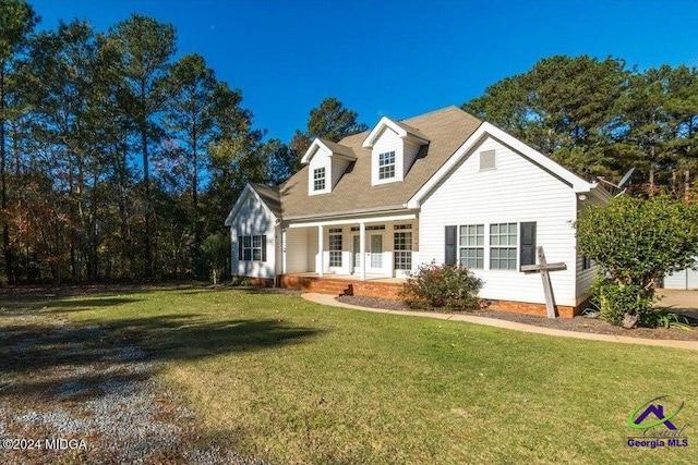 new england style home featuring a front lawn and covered porch