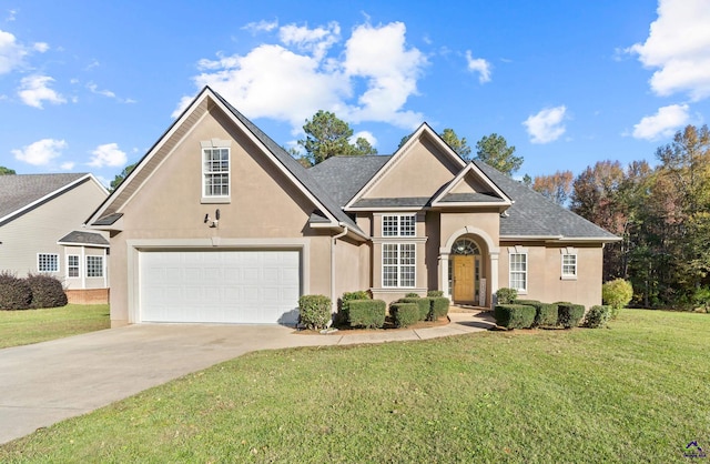 view of property featuring a garage and a front lawn