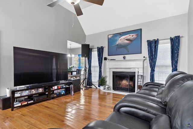 living room featuring hardwood / wood-style floors, plenty of natural light, and ceiling fan with notable chandelier