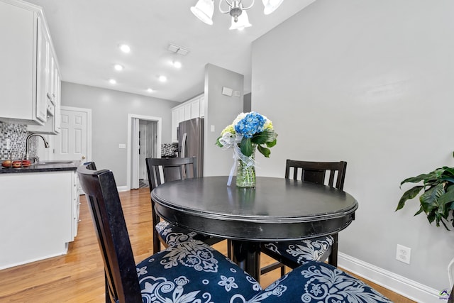 dining space featuring sink and light wood-type flooring