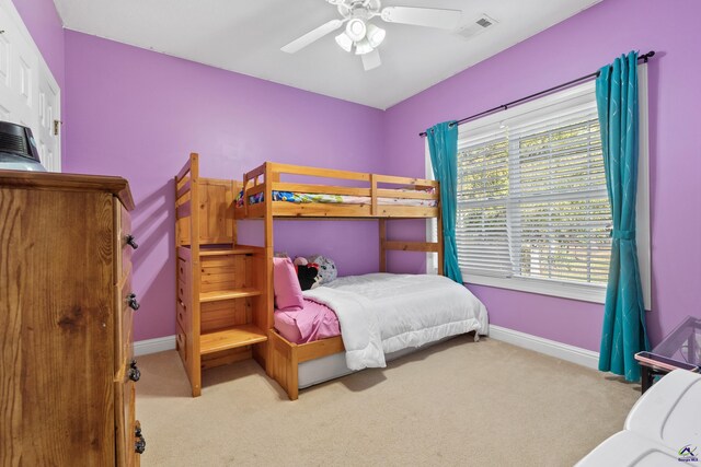 bedroom with ceiling fan and light colored carpet