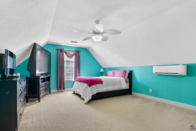 carpeted bedroom with a wall mounted air conditioner, a textured ceiling, ceiling fan, and lofted ceiling