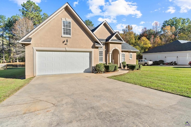 front facade with a garage and a front lawn