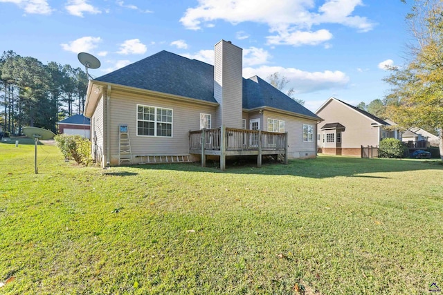 back of property featuring a lawn and a deck