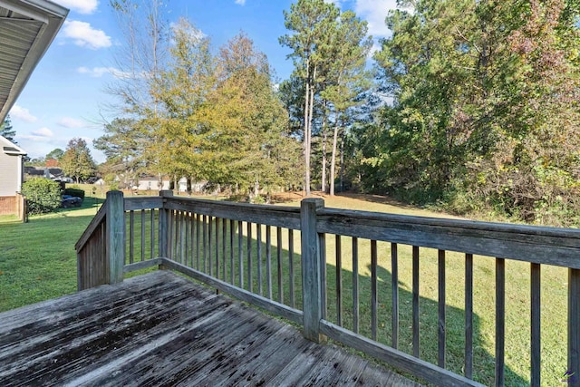 wooden terrace with a lawn