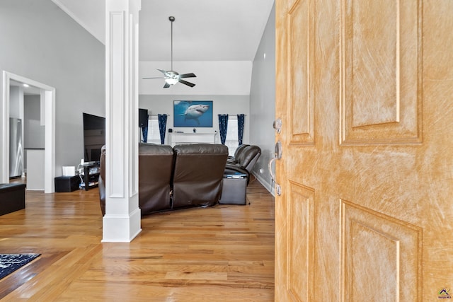 living room featuring hardwood / wood-style flooring, ceiling fan, high vaulted ceiling, and decorative columns