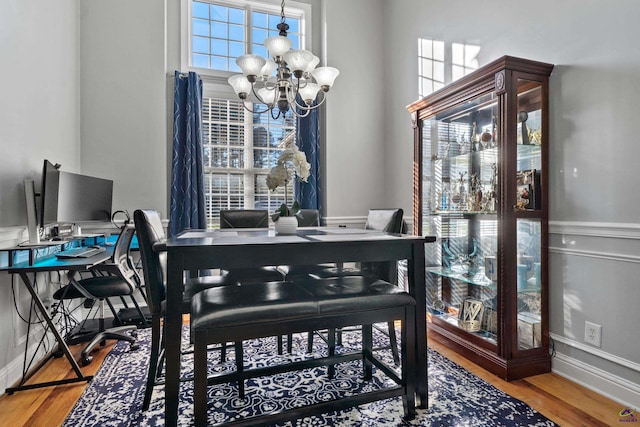 dining room with a chandelier and wood-type flooring