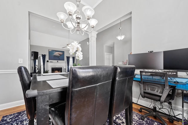 dining area featuring hardwood / wood-style flooring, ceiling fan with notable chandelier, and ornamental molding